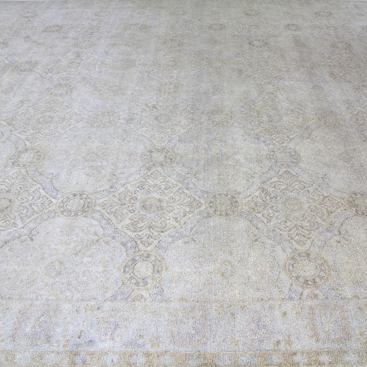 Close-up view of decorative patterned carpet in light neutral color.