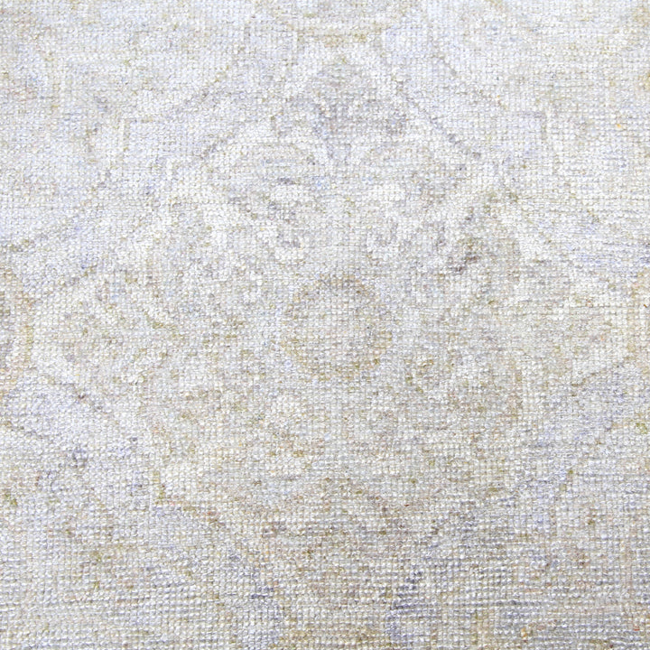 Close-up of elegant, neutral-toned fabric with subtle floral pattern.