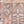 Close-up of textile with geometric and botanical pattern in muted colors.