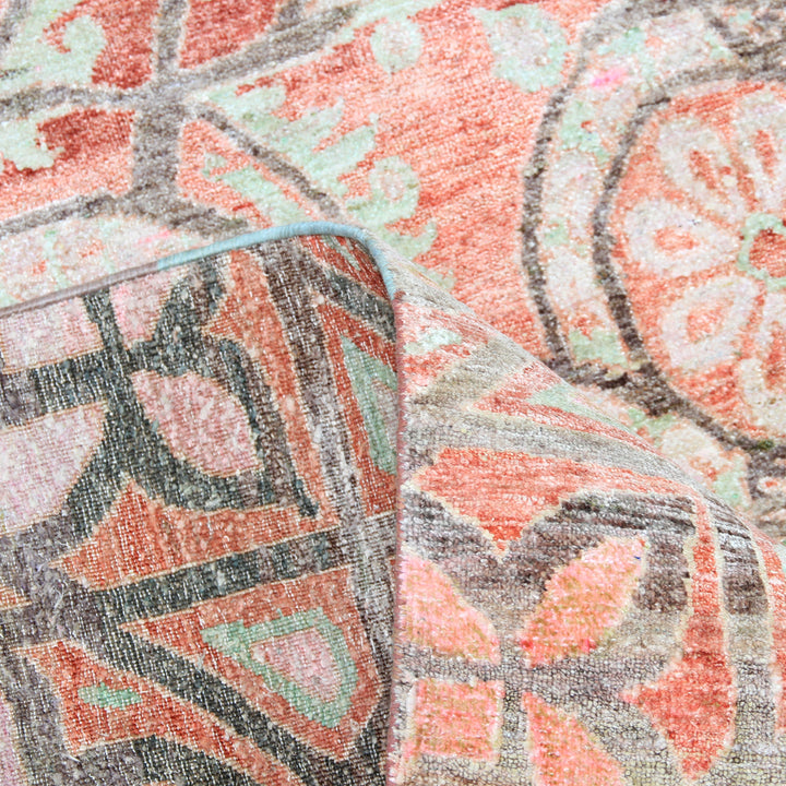 Close-up of vintage floral geometric fabric with visible folds.