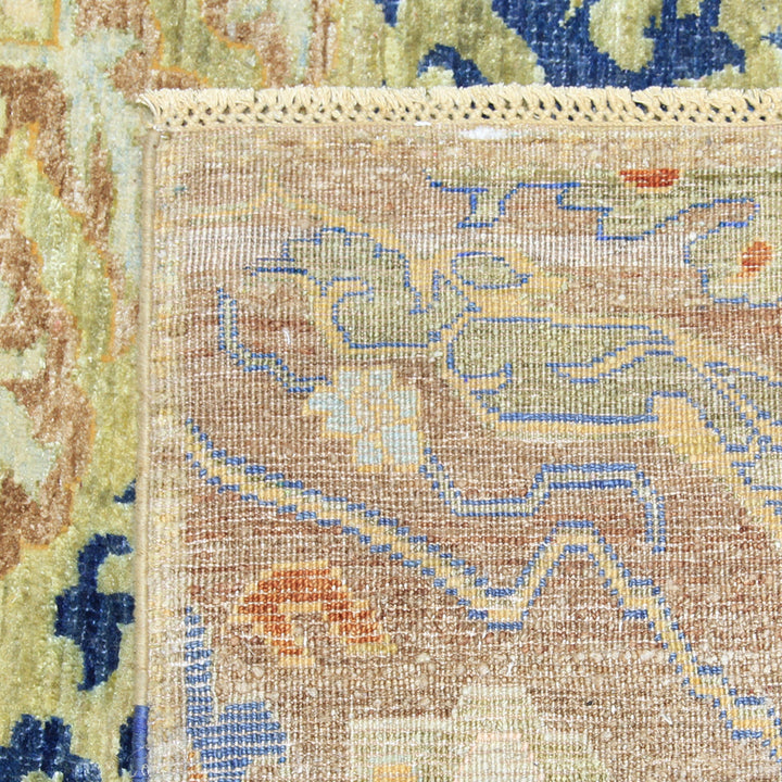 Intricately designed vintage rug with floral motifs and woven borders.