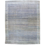 Ornate rug with intricate geometric and floral designs in blues.