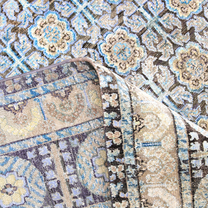 Intricate floral and geometric patterned rug in earthy tones and blue.