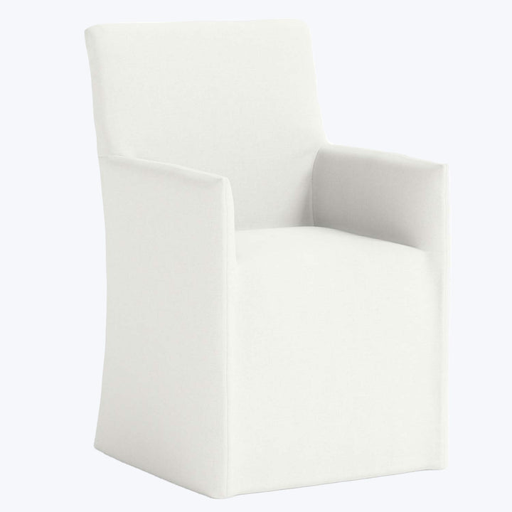 Minimalist white armchair with clean lines in modern interior setting.