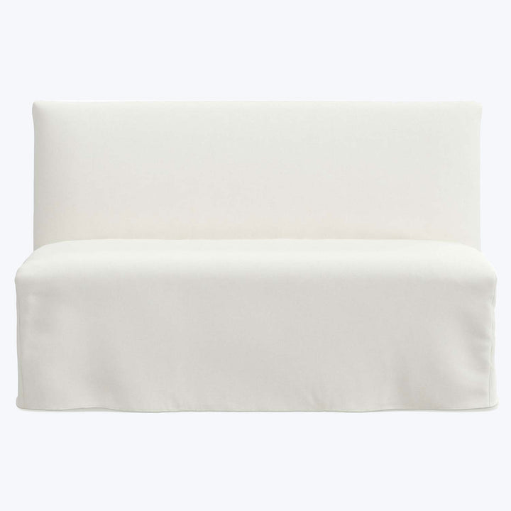 Modern white sofa with minimalist design and seamless slipcover.