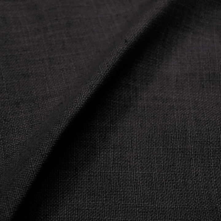 Close-up of black fabric with subtle sheen and fine weave.