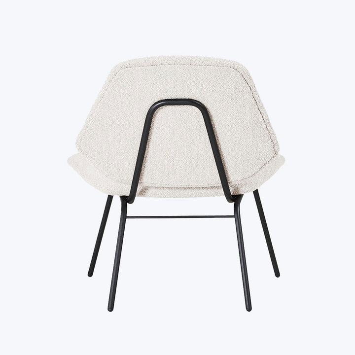 Modern chair with curved design, light upholstery, and sleek metal