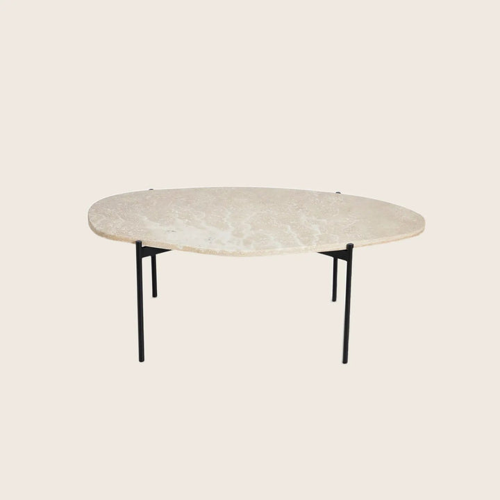 Modern coffee table with organic stone-like top and minimalistic legs.