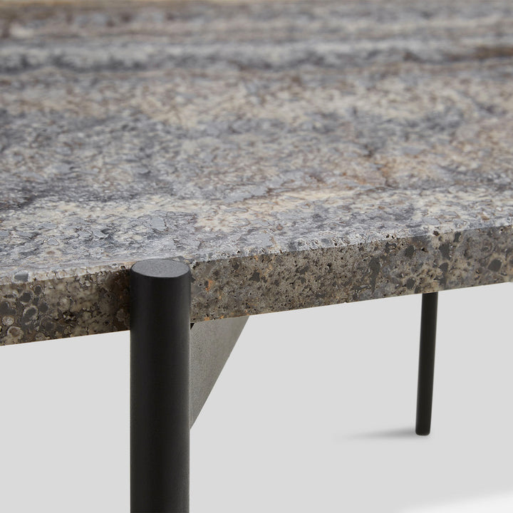 Modern industrial table corner with speckled gray composite material top.