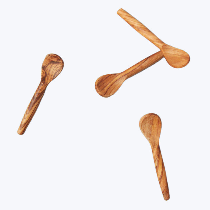 Three wooden kitchen spoons with different designs and wood types.