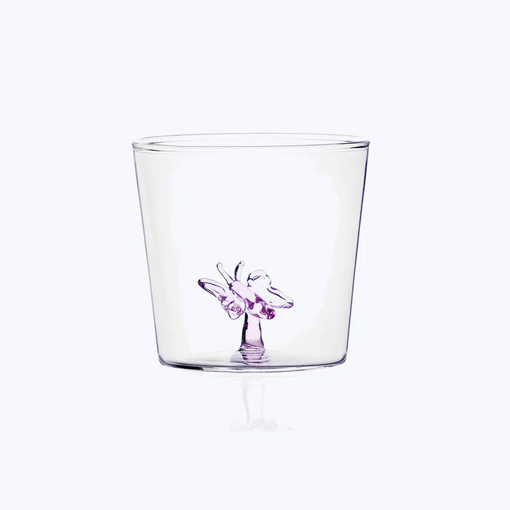 Glass cup with purple ballerina illustration on bottom center.