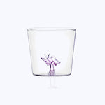 Glass cup with purple ballerina illustration on bottom center.