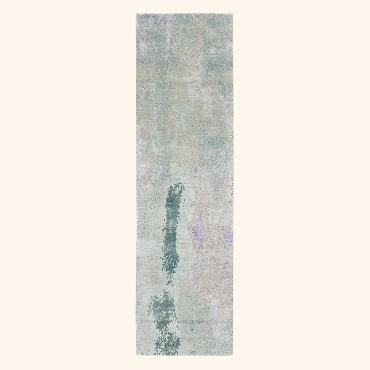 Vintage abstract area rug with muted blues and greens design.