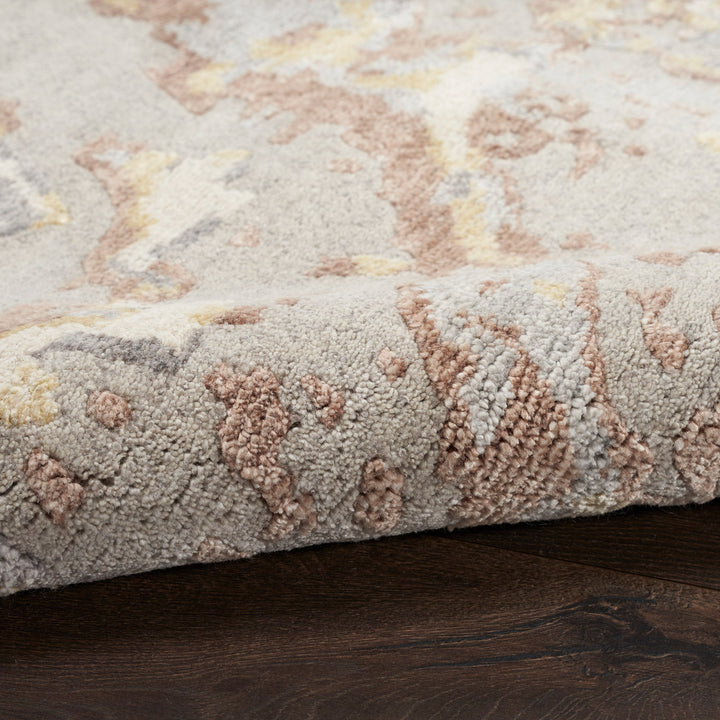 Plush textured area rug with raised pattern in neutral tones.
