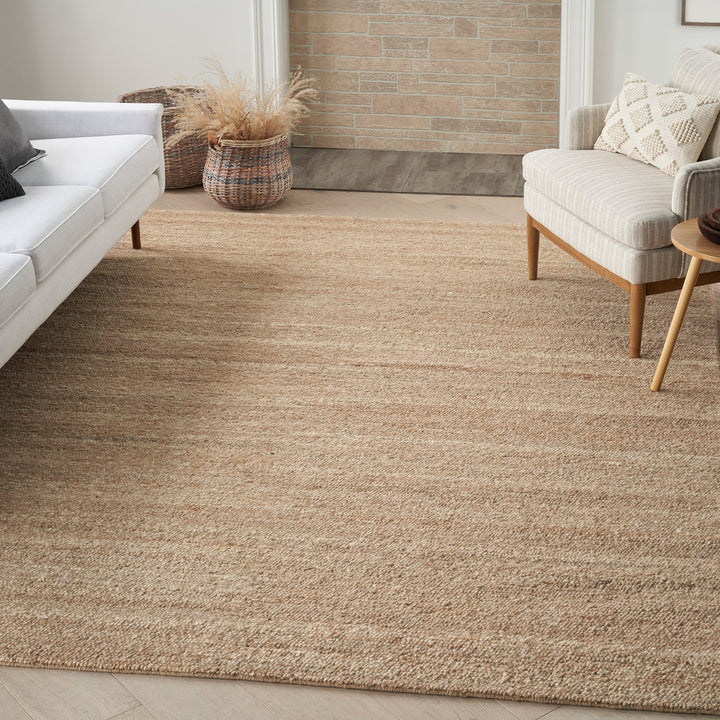 Modern, minimalist interior with neutral tones, textured rug, and natural elements.