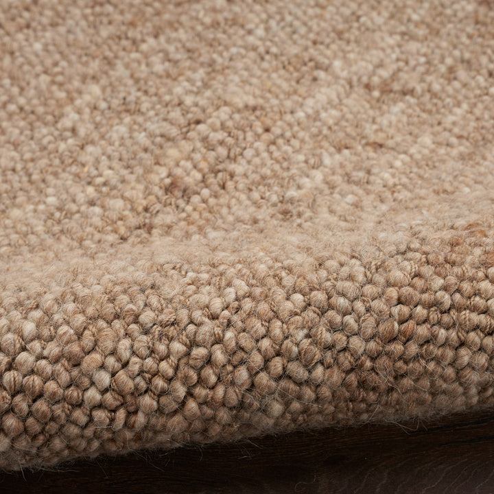 Close-up of loop pile carpet in shades of beige and brown.