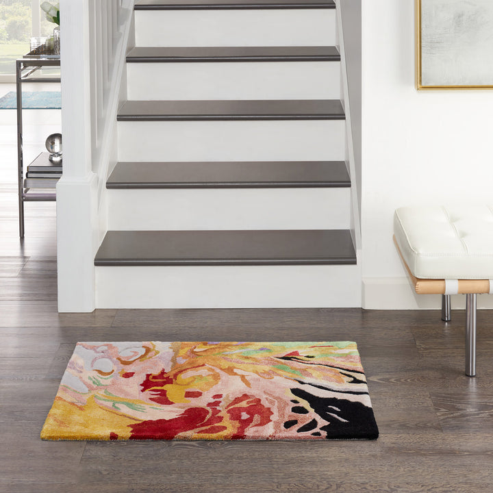 Modern home interior with staircase, colorful rug, and artwork display