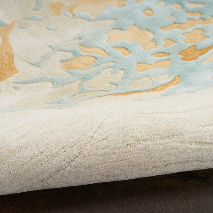 Close-up view of folded rug with ornamental design on carpet.