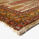 Intricate, colorful rug with traditional motifs showcases expert craftsmanship.