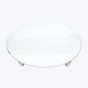 Simple round white ceramic plate with textured surface against white background.