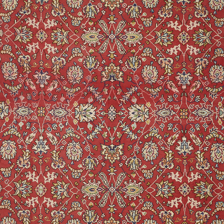 Exquisite handwoven rug with intricate floral motifs in warm red.