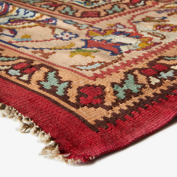 Close-up of a vibrant, handcrafted Persian carpet with intricate patterns.