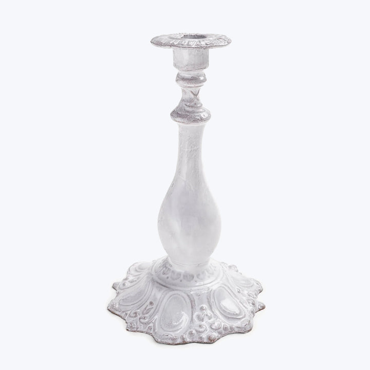 Vintage white and silver candlestick with ornate decorative design.