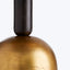 Close-up of a metallic golden object with a black handle.