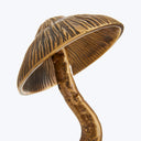 Bronze mushroom sculpture with textured cap and ridged gills.