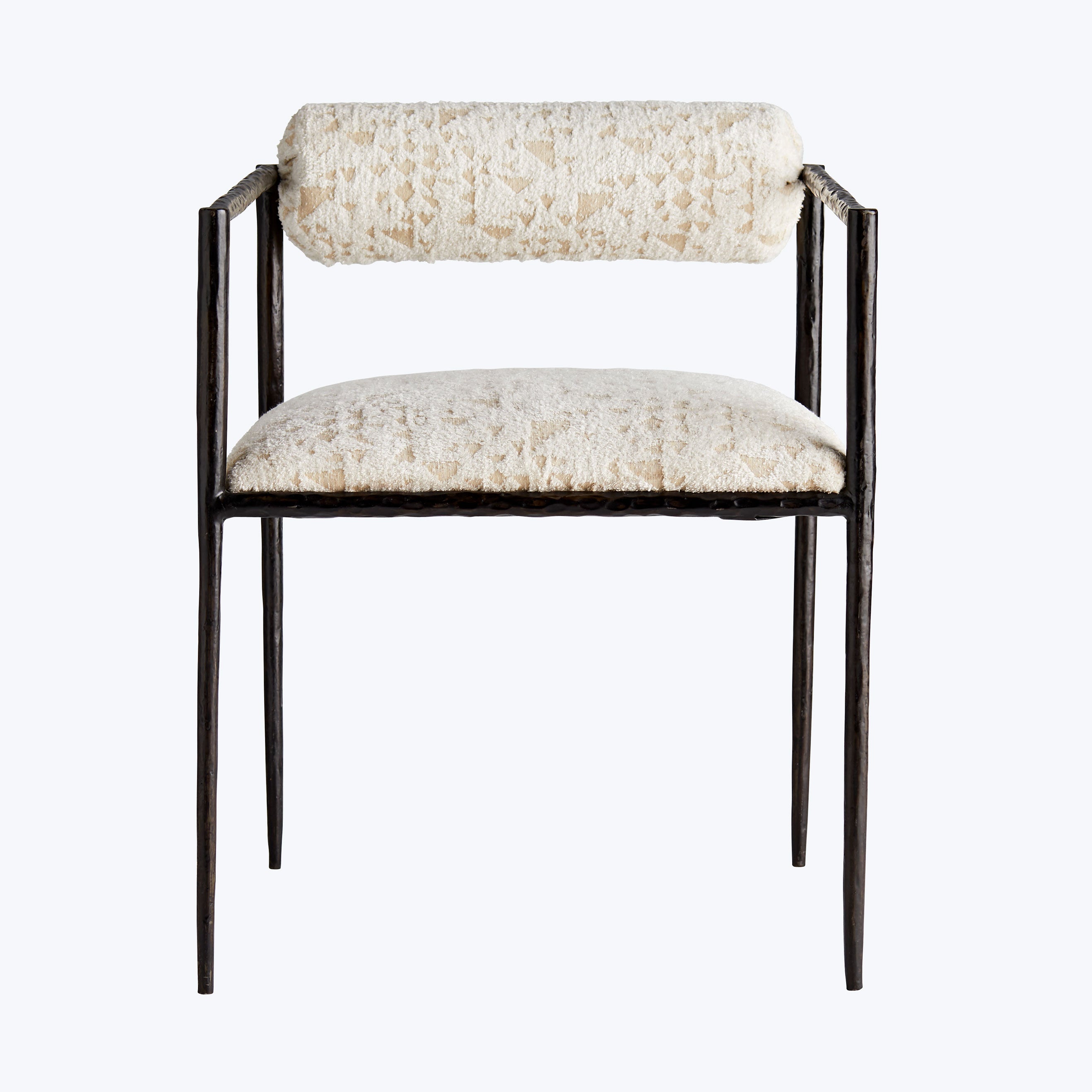 Minimalist metal-framed chair with cushioned neutral fabric in stylish interior.