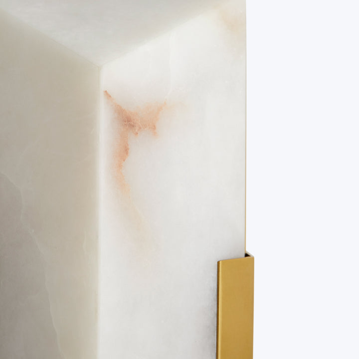 A close-up view of a minimalist, luxurious alabaster furniture piece.