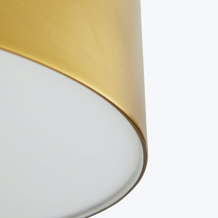 Close-up view of a golden-edged object with glossy white surface.