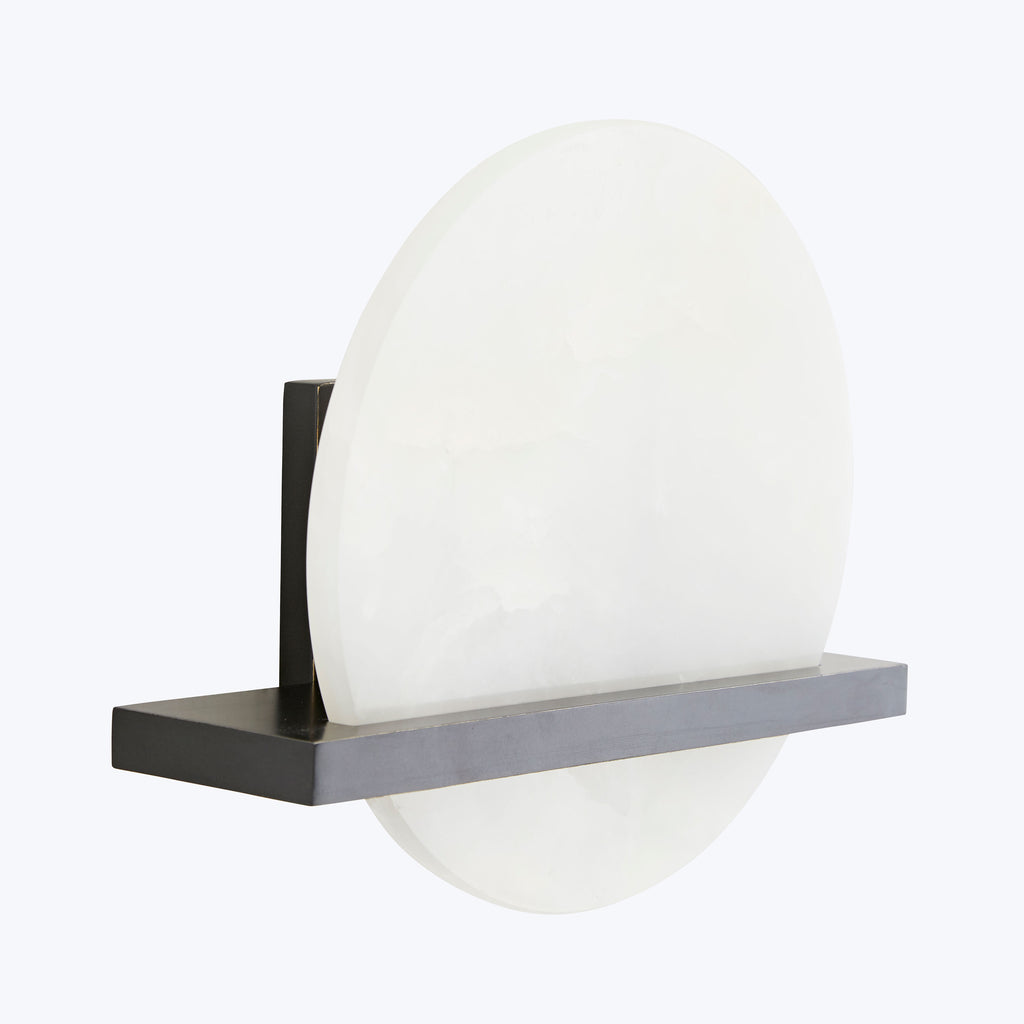 Minimalist wall-mounted light fixture with sleek design and soft lighting.