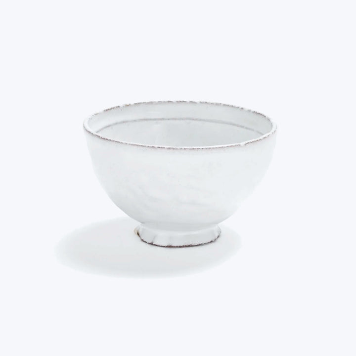Simple white bowl with rustic finish on white background
