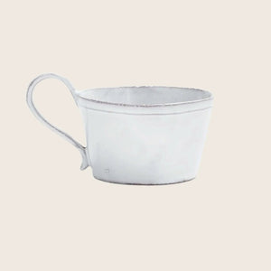 Rustic white mug on white background with slightly distressed look.