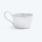 Rustic white mug on white background with slightly distressed look.