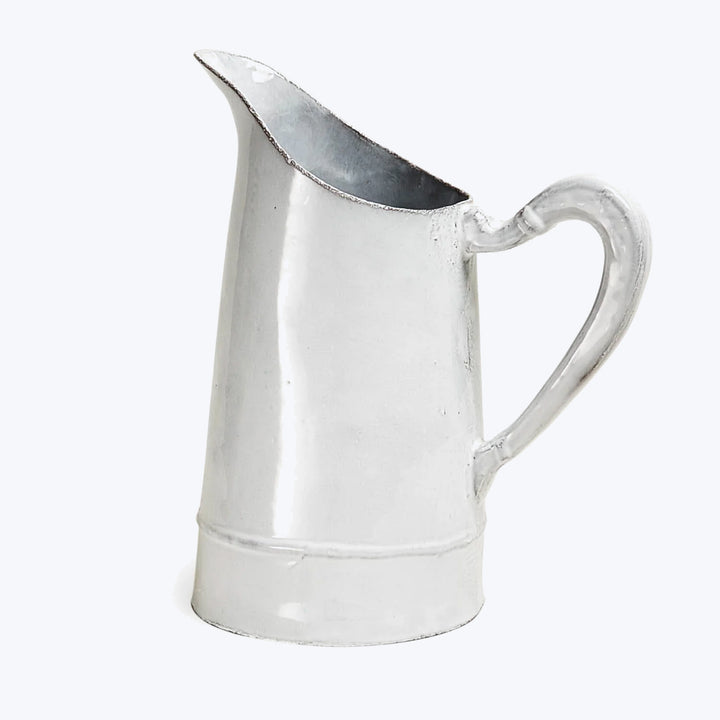 Classic metal pitcher with elegant design for serving beverages.