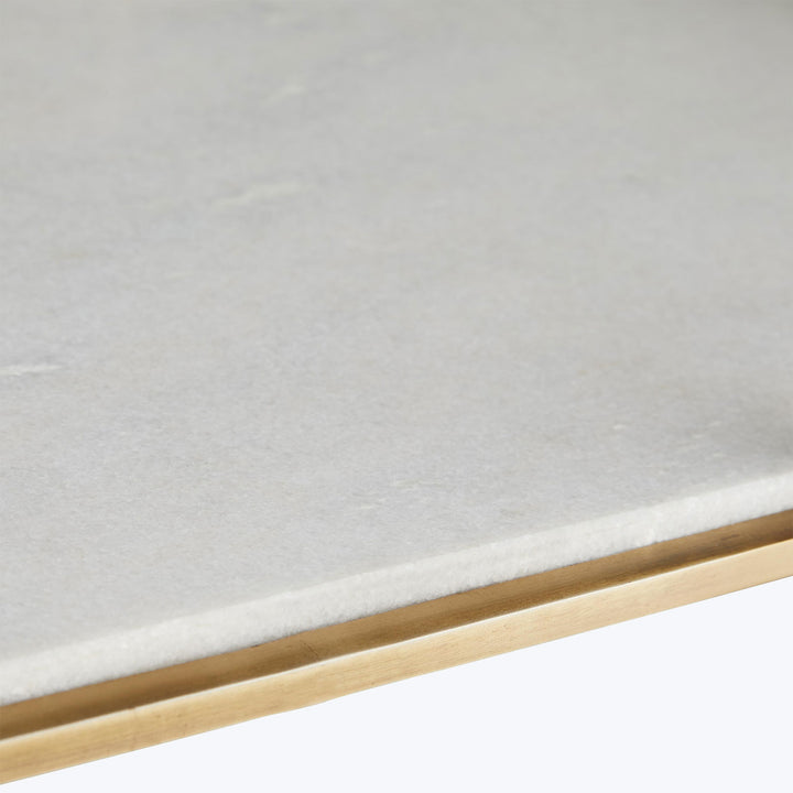 Close-up view of textured gray surface meeting pale golden-brown frame.