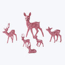 Six sparkly pink deer figurines in various poses on display.