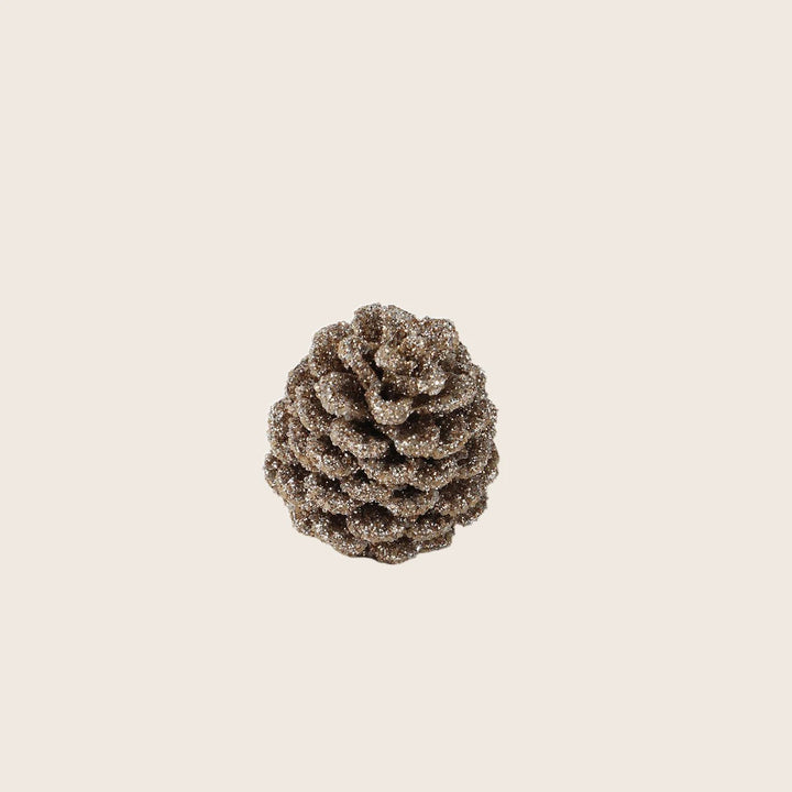 Glittery pine cone decoration for festive seasons like Christmas.