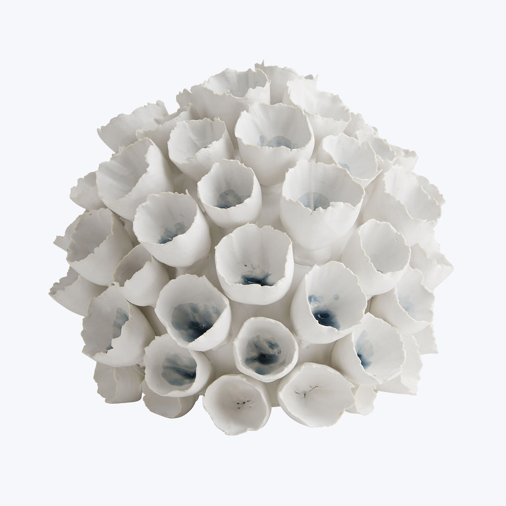 Artistic arrangement of white flower-like structures forms a spherical bouquet.