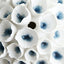 Artistic collection of white tubular sculptures with blue accents