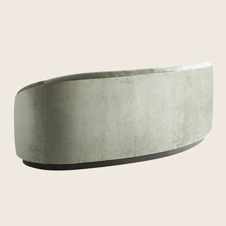 Modern curved sofa with plush texture and sleek design.