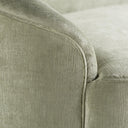 Close-up detail of upholstered furniture in light green/grey fabric.