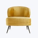 Modern armchair in mustard yellow velvet upholstery exudes elegant simplicity.