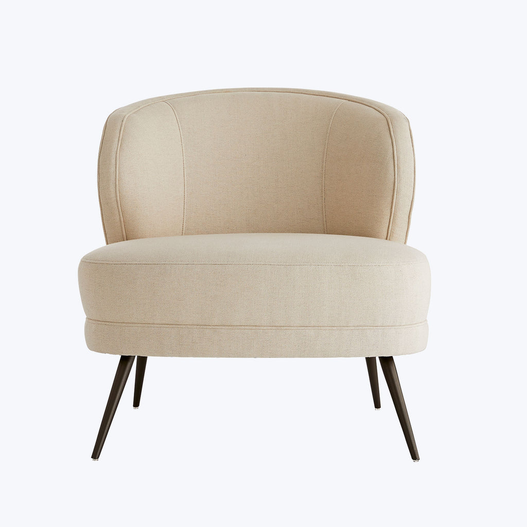 Modern armchair with curved backrest and splayed wooden legs.