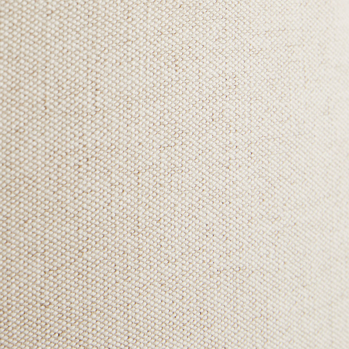 Close-up of fine, tightly woven beige fabric with uniform pattern.