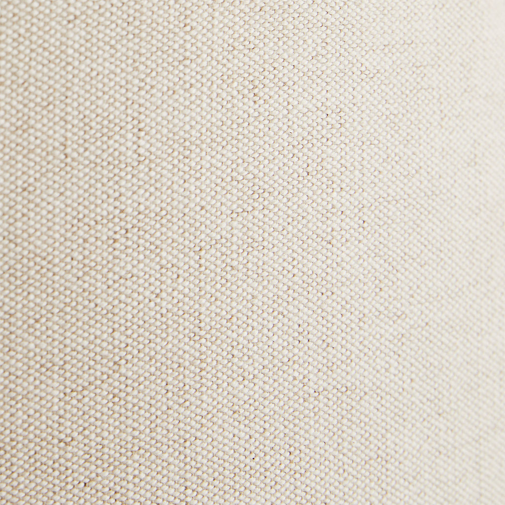 Close-up of fine, tightly woven beige fabric with uniform pattern.