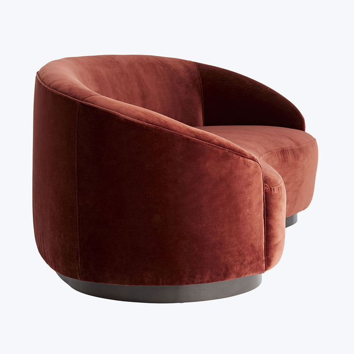Stylish modern chair with plush curved structure and rich upholstery.