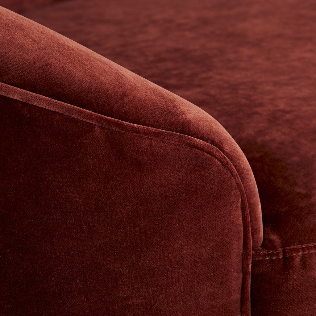 Close-up of a plush, maroon velvet furniture piece showcasing craftsmanship